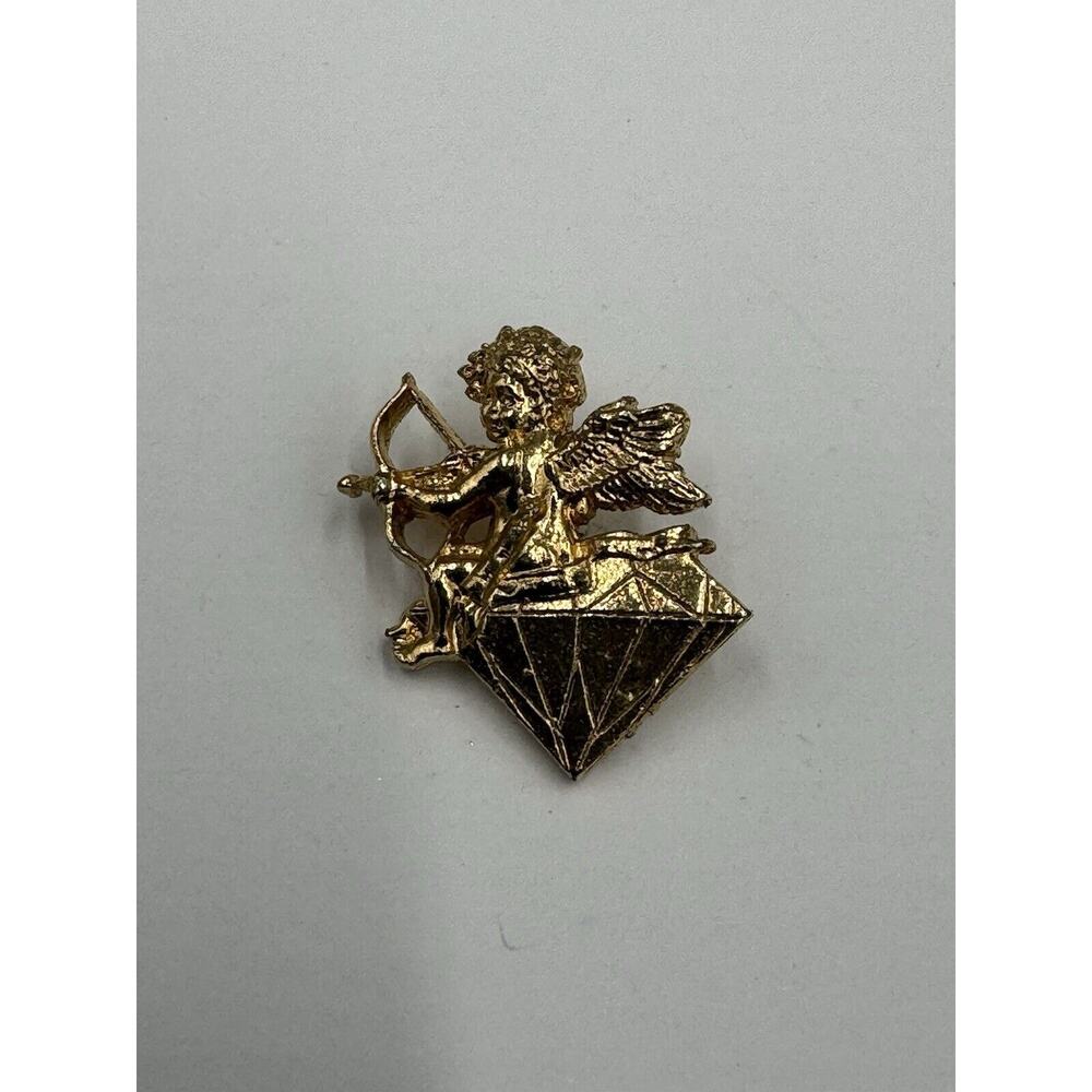 Gold Colored Angel With Bow & Arrow Sitting On Diamond